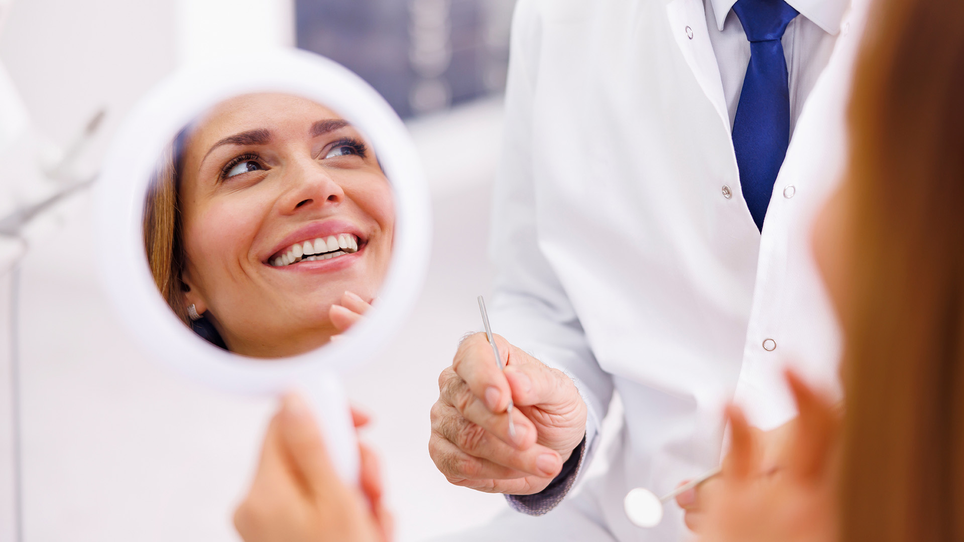 A dental professional assisting a patient with oral care, set against a clean and modern dental office backdrop.