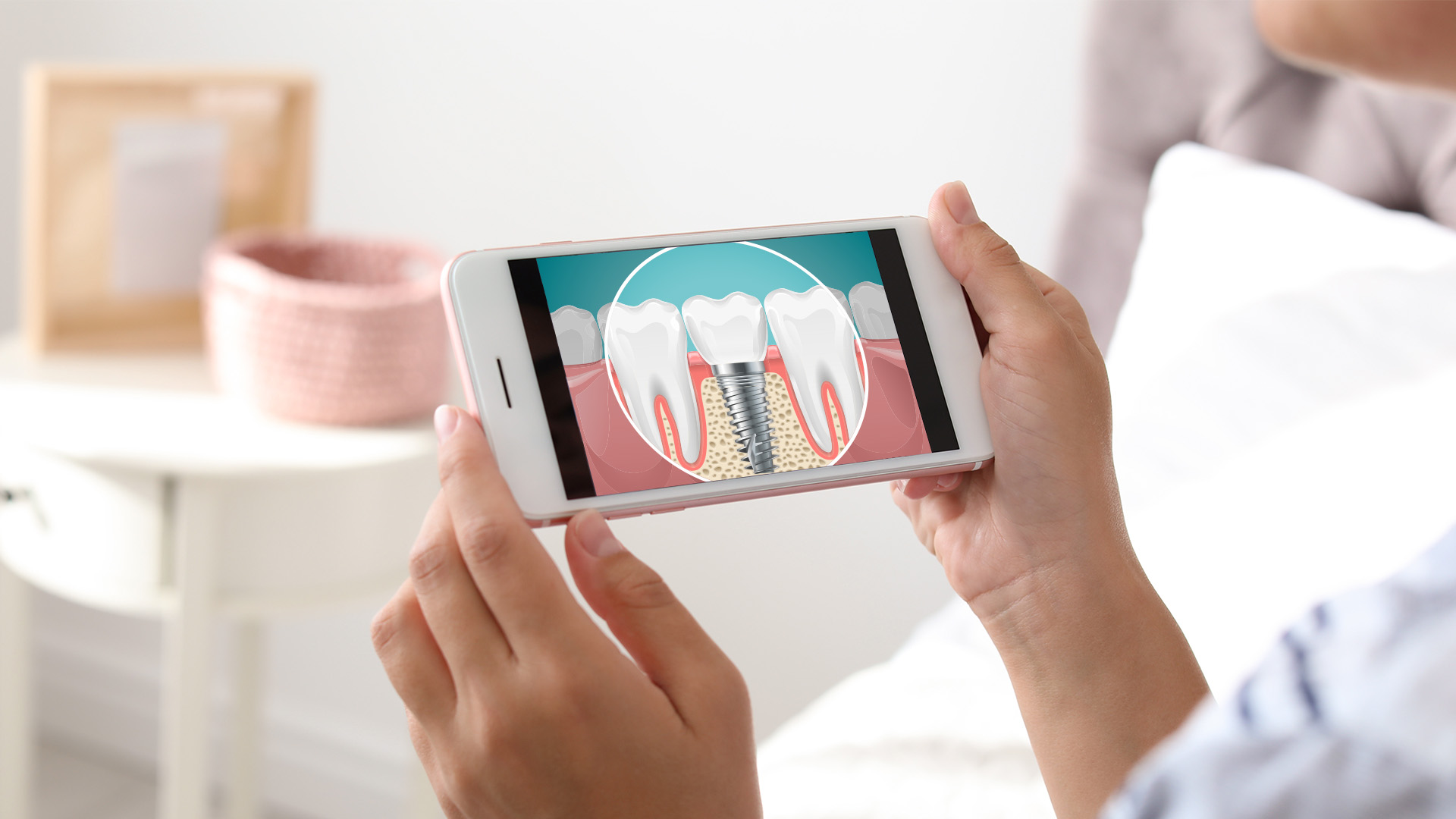 An image of a person holding a smartphone with an app displaying a detailed view of a tooth, likely for dental care or oral health information.