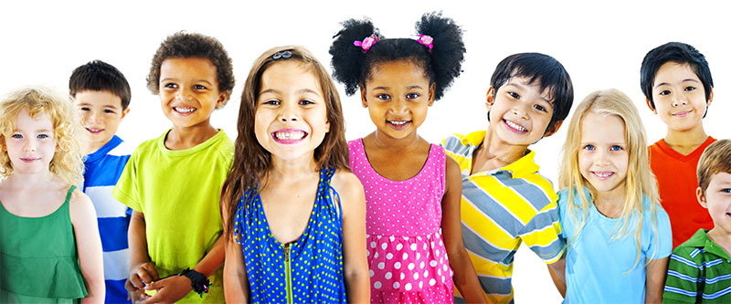 The image shows a diverse group of children and adults, likely posing for a photo or participating in an activity, with various expressions and attire.