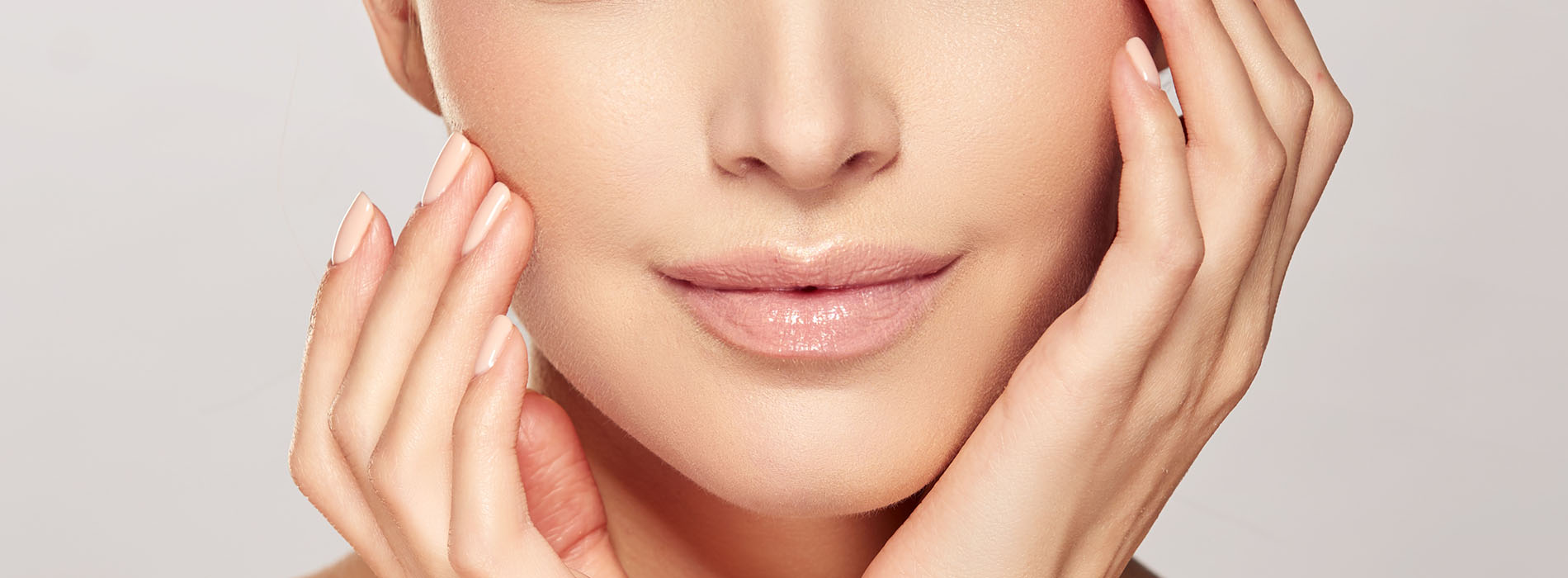 A woman with a clear complexion undergoing a facial treatment in a clean, professional environment.