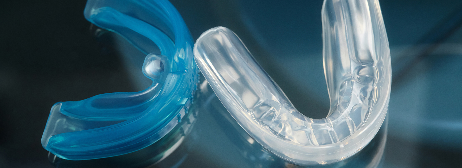 Clear plastic dental appliance with a blue tint.