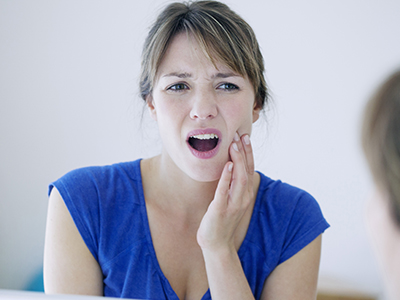 A woman with her hand on her chin, expressing concern or surprise.